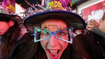 A reveller joins the crowds in Times Square ahead of celebrations of the New Year's Eve, in New York City, New York. Reuters