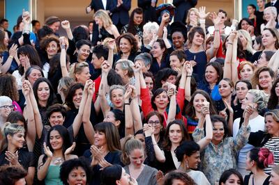 Actresses and female directors stand on the steps of the red carpet in protest of the lack of female filmmakers honored throughout the history of the festival. EPA