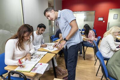 A teacher helps at language student at the Eton Institute in Dubai. Antonie Robertson / The National