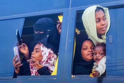 War-displaced Sudanese saying goodbye to locals in Port Sudan on the Red Sea before they start their journey home in the the southern city of Singah, November 2024. AFP