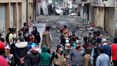 Anti-government protesters and security forces face off on River Street during ongoing protests in Baghdad. AP Photo
