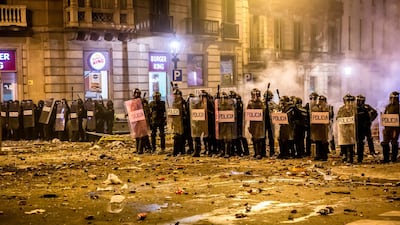Riot police stand behind shields during a demonstration in Barcelona, Spain. Bloomberg