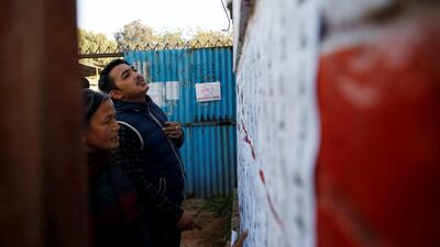 People search for their names on the voting list. Navesh Chitrakar / Reuters