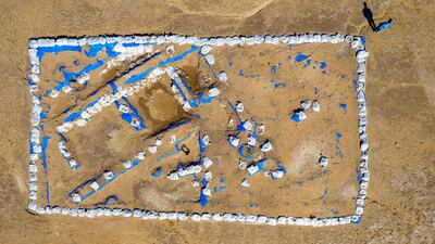 Iraqi archaeologist Baqer Azab Wali standing by the newly-excavated trench at the site