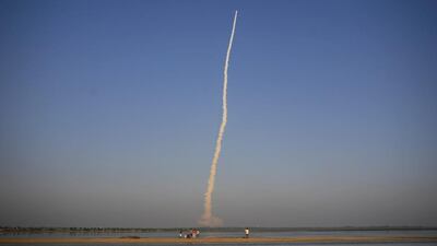 People watch the PSLV-C27 take off carrying India's fourth navigational satellite, in Sriharikota. Arun Sankar K / AP Photo