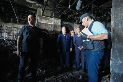Iraq's Prime Minister Mohammed Shia Al Sudani, centre, inspects the damage at the Corniche Hypermarket Mall in Kut on Thursday. AFP