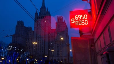 A neon sign displays the latest Russian ruble euro dollar exchange rate outside a currency exchange bureau in Moscow, Russia, on Tuesday, December 16, 2014. The rouble sank to a record, deepening Russia's currency crisis, as people scrambled to convert their money into dollars after a surprise interest-rate increase failed to shore up investor confidence. Andrey Rudakov / Bloomberg