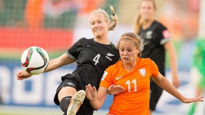 New Zealand's Katie Duncan, left, and the Netherlands' Lieke Martens vie for the ball during their Group A football match at Commonwealth Stadium on the opening day of the Fifa Women's World Cup in Edmonton, Canada on June 6, 2015. AFP PHOTO/ GEOFF ROBINS