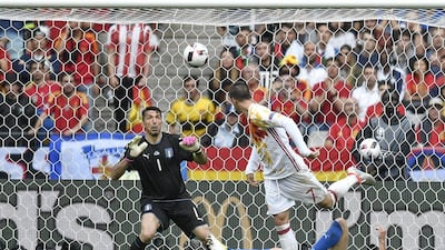 Italy goalkeeper Gianluigi Buffon, left, watches as Spain's Alvaro Morata attempts a header at goal during the Euro 2016 round of 16 soccer match between Italy and Spain, at the Stade de France, in Saint-Denis, north of Paris, Monday, June 27, 2016. (AP Photo/Martin Meissner)