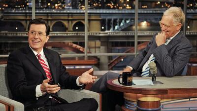 Stephen Colbert, left, host of the Colbert Report on the Comedy Central Network, has a laugh on stage with host David Letterman on the set of the Late Show with David Letterman, in New York. Colbert says on a visit to the late-night show he’ll take over next year he’s obviously “thrilled” to be succeeding David Letterman. AP