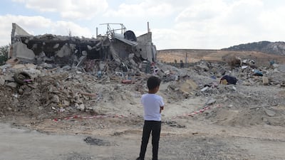 A Palestinian child surveys damage caused by an Israeli raid on the village of Kafr Dan, near the occupied West Bank city of Jenin. EPA