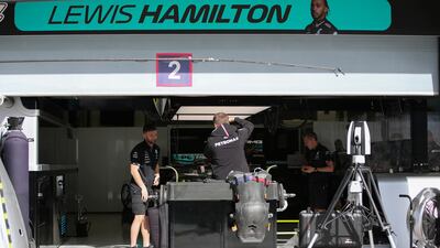 Mechanics works on Hamilton's car ahead of the first race in Bahrain. EPA