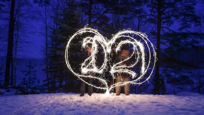 Revelers write "2021" in a heart shape with sparkler candles in Lahti, Finland. EPA