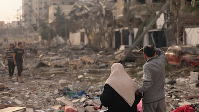 Palestinians inspect the destruction from Israeli air strikes in Gaza city's Al Rimal district on Tuesday. AFP