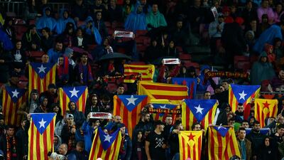 Supporters hold 'Estelada', the pro-independence Catalan flag, during a game at Camp Nou this month. Manu Fernandez / AP Photo
