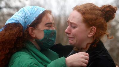 Women paying their respects to Sarah Everard console each other at a memorial site at Clapham Common, London. Reuters