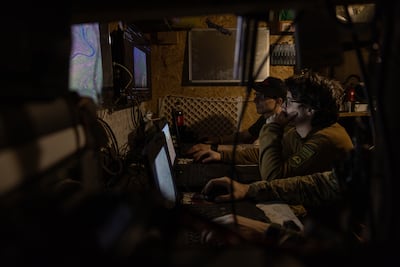 Members of the Lava Unmanned Systems Regiment monitor screens as they wait for a combat mission with ground robots. Getty