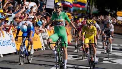 Wout Van Aert crosses the finish line ahead of Michael Matthews, left, and Tadej Pogacar, right, to win Stage 8 of the Tour de France on Saturday, July 9, 2022. AP