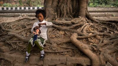 A girl plays with a doll in Guwahati, India. Unicef estimates that at least 1.5 million girls under 18 get married in India every year, making it home to the largest number of child brides in the world. AP