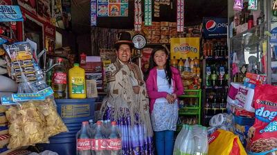 Lucia Mayta, 43, and her daughter Luz Cecilia, 12, inside their bodega in La Paz. Lucia studied until the fourth grade of primary school, and knows how to read and write and do basic math. Lucia runs a bodega, and the family live in a back room. She hopes to build a house in the future. Luz Cecilia is in seventh grade and wants to be a singer. David Mercado / Reuters