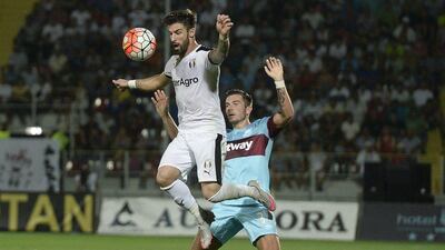 West Ham's Lewis Page, right, and Astra Giurgiu's Gabriel Enache, left, challenge for the ball during the Europa League, third qualifying round, second leg. Octav Ganea / AP Photo