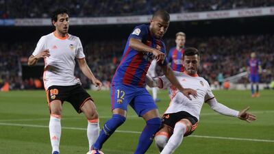 Barcelona’s Rafinha Alcantara, centre, duels for the ball with Valencia’s Jose Luis Gaya. Manu Fernandez / AP Photo
