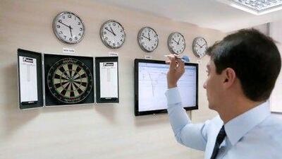 1pm - Bullseye: with trades completed, Marwan takes a stress break just 10 minutes before the close of the Dubai exchange. Duncan Chard for the National.