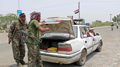 Fighters with the Security Belt Forces search the trunk of a car at their checkpoint near the south-central coastal city of Zinjibar in south-central Yemen. AFP