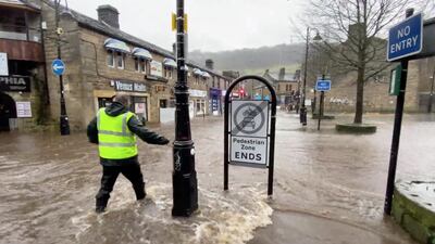 A man wades through a flooded street due to Storm Ciara in Hebden Bridge, West Yorkshire, Britain. REUTERS