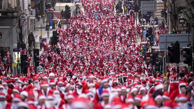 Thousands of Scots dressed in Santa suits make their way through the streets of Glasgow to raise money for charity. Getty Images