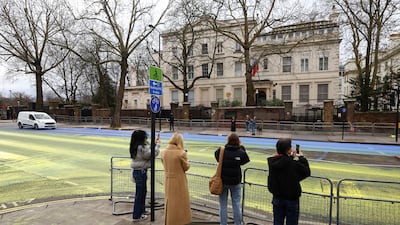 Passersby take pictures of the protest with their phones