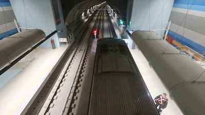 A security worker stands next to a train on the new Metro Line 4 subway. Mario Tama / Getty Images)