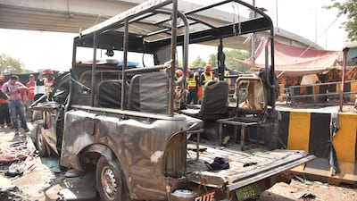 Officials examine the site of the bomb blast. EPA