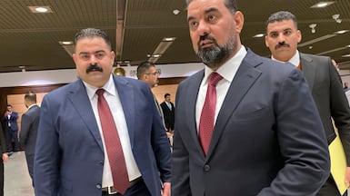 Haibet Al Halbousi, centre, arrives for the first session of Iraq's new parliament, at which he was elected speaker. AP