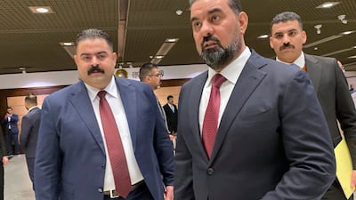 Haibet Al Halbousi, centre, arrives for the first session of Iraq's new parliament, at which he was elected speaker. AP