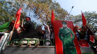 Anti-coup protesters demonstrate next to an image of General Aung San, Burmese independence leader and father of deposed Myanmar leader Aung San Suu Kyi, during a rally that coincided with the anniversary of his birth, in Yangon, Myanmar. AP Photo