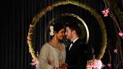 Newlyweds Priyanka Chopra, 36, and Nick Jonas, 26, pose for a photograph during a reception at a hotel in New Delhi on December 4, 2018. Photo: AFP