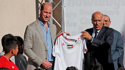 Head of the Palestinian Football Federation, Jibril Rajoub, offers a football jersey to Britain's Prince William in the West Bank city of Ramallah. Ahmad Gharabli / AFP