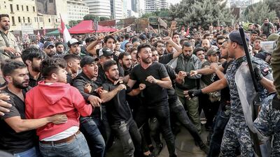 Riot police tries to separate Hezbollah supporters shouting pro-Hezbollah slogans and anti-government protesters, during a ninth day of anti-government protests in Beirut, Lebanon. EPA