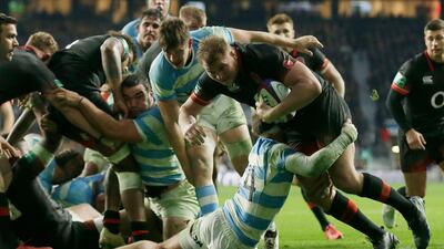 England's Dylan Hartley, right, is tackled by the Argentine Ramiro Moyano at Twickenham on Saturday. Tim Ireland / AP Photo