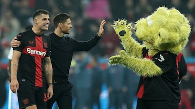 Xabi Alonso with Granit Xhaka and the club mascot after Bayer Leverkusen beat Bayern Munich at BayArena on February 10, 2024. Getty Images