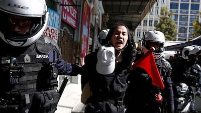 Riot policemen detain a protester in Athens. EPA