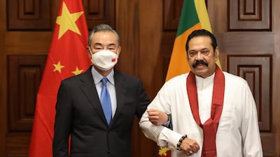 Sri Lankan Prime Minister Mahinda Rajapaksa, right, welcomes Chinese Foreign Minister Wang Yi during their meeting in Colombo, Sri Lanka on Sunday. Photo: EPA