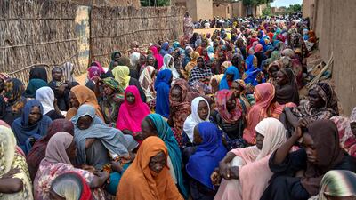 Sudanese wait to receive meals in El Fasher, in the western Darfur region. AFP