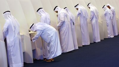 Sharjah, UAE. September 24, 2011: Emirati men cast their votes at the Sharjah Expo Centre FNC voting station. Satish Kumar / The National )