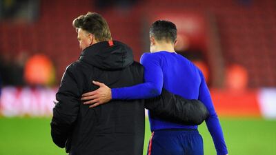 Manchester United manager Louis van Gaal congratulates striker Robin van Persie after their team's 2-1 Premier League win against Southampton on Monday. Mike Hewitt / Getty Images / December 8, 2014