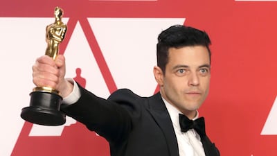 Best Actor Rami Malek poses with his award backstage at the Oscars. Reuters
