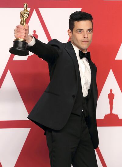 Best Actor Rami Malek poses with his award backstage at the Oscars. Reuters