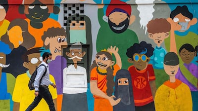 A man wearing a face mask as a preventive measure against the coronavirus walks along a street in New Delhi. AFP