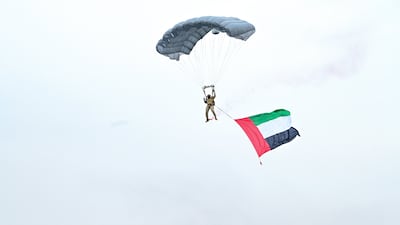 A parachutist prepares to land on the parade ground. Photo: Dubai Media Office